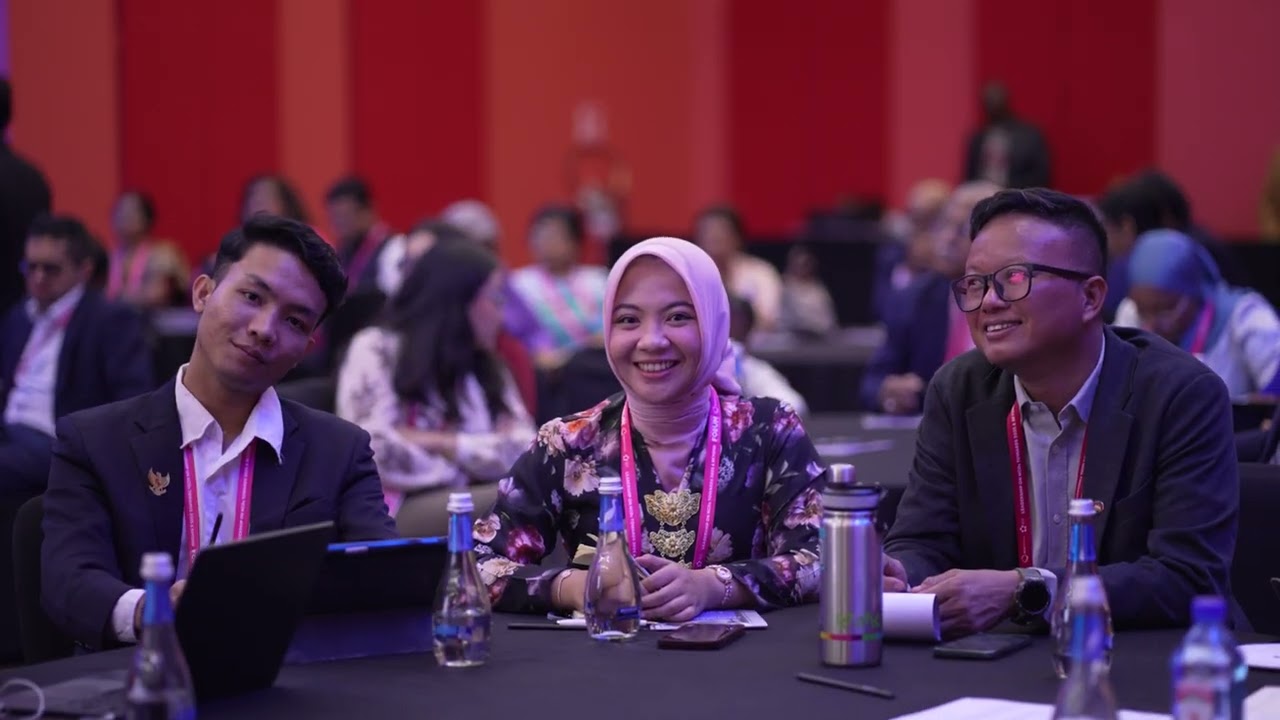 Delegates of the NCD Alliance Forum Smiling while sitting at a table 
