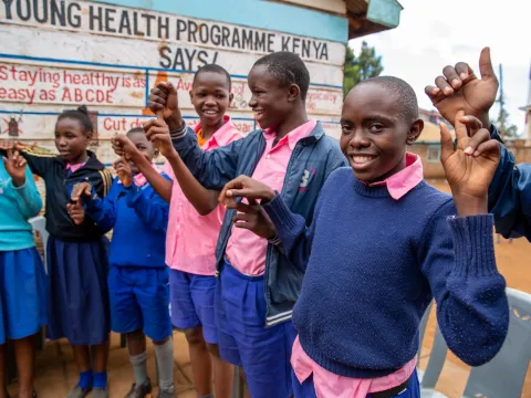 Children holding hands in Kenya, still from Facing Forward video series 