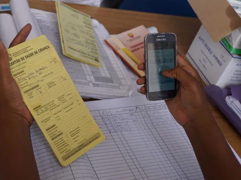 A health worker uses the mVacciNation mobile app to record vaccination data Mozambique