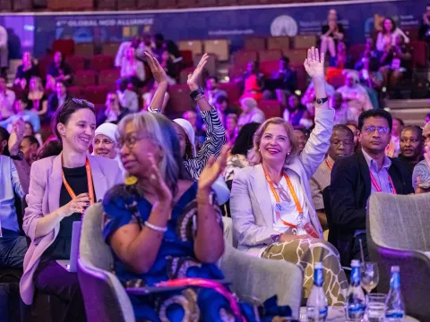 Delegates raising their hands at the global forum