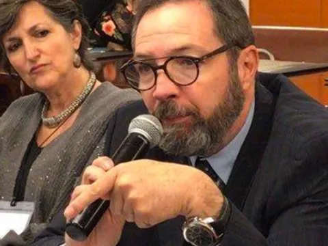 portrait of latin american man speaking into a microphone living with NCDs