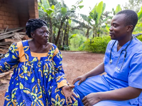 A rural doctor talks to an elderly patient during a medical examination 