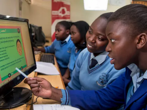 girls in Africa looking at a computer