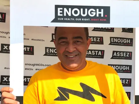 Jamaica's Minister of Health, Dr Christopher Tufton, framed by NCDA's Enough campaign at the WHO Walk the Talk event in Geneva, 20 May 2018