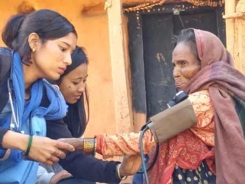 Community health workers check the blood pressure of a woman with breathing difficulties, Achham district, Nepal, Feb 2018