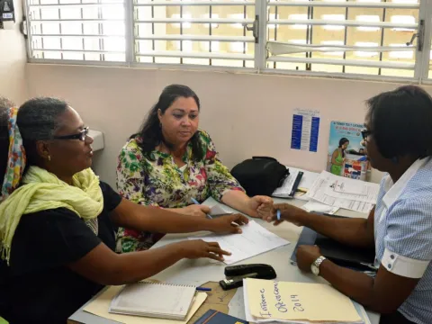 Patients speak with a health professional at an integrated care clinic in the Dominican Republic.