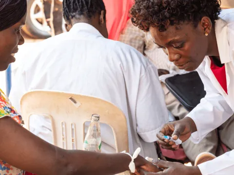 A woman donates blood at a blood donation street point in Kampala, Uganda.