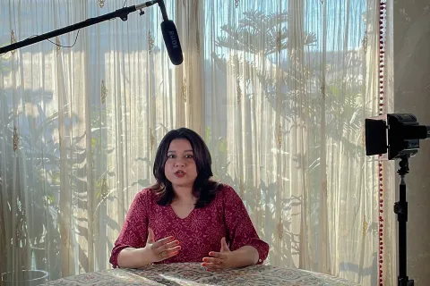 Woman being interviewed with microphone above her head about NCDs