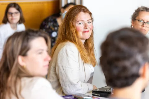 Smiling lady with red hair at NCD civil society event