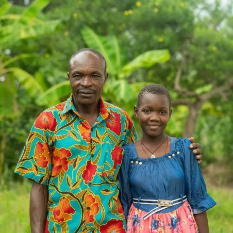 Tasha, leukemia survivor from Uganda, with her grandfather. Still from Facing Forward series