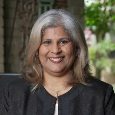 Smiling lady in front of tree posing for portrait
