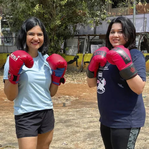 Two women wearing boxing gloves in India 
