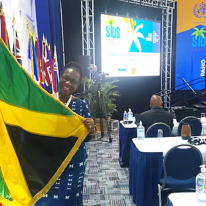 smiling Caribbean woman with Jamaican flag